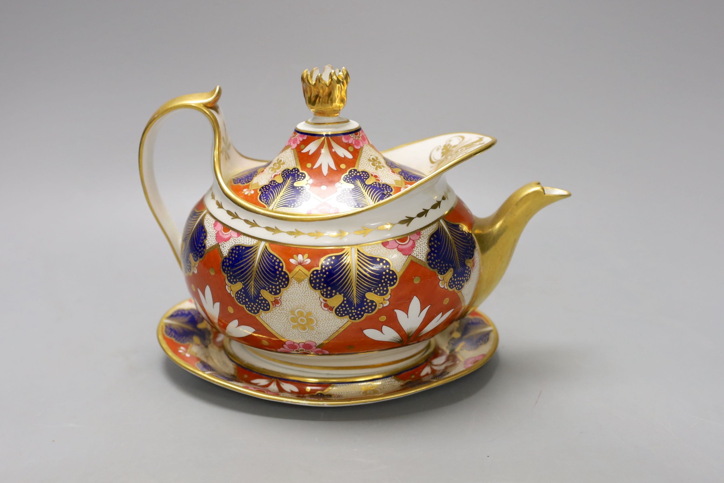 A Barr Flight and Barr Worcester teapot cover and stand painted with an Imari pattern, c.1805, 23 cm long